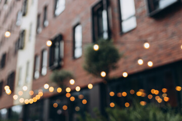 Decorative outdoor string lights at night time, Defocused Background, night city life backdrop,...