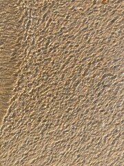 Sunlight creates a pattern on a wavy water surface