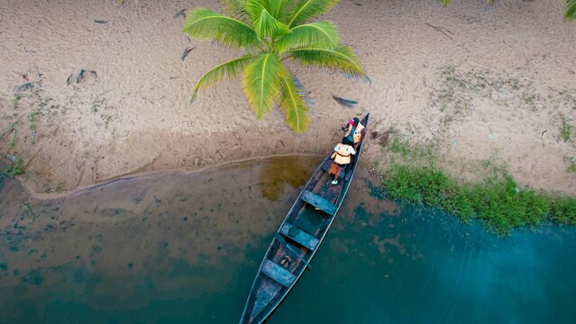 Aerial Shot Of People In A Kayak In The Water By The Beach