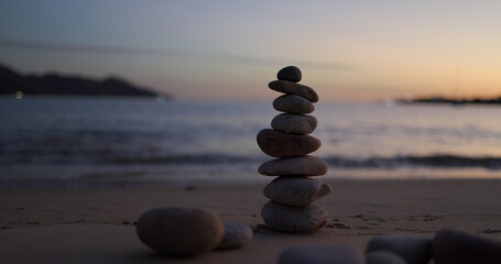 Fototapeta na wymiar Zen stones on the beach in sunset time