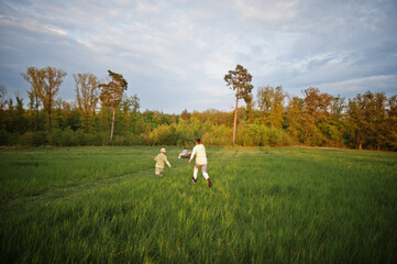 Brothers running and having fun together at meadow.