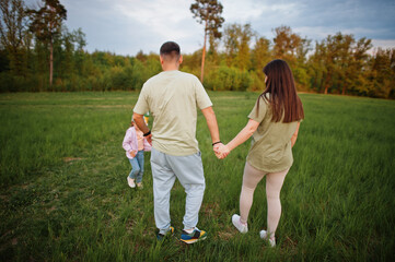 Fototapeta premium Couple with kids together at meadow.