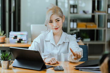 Businesswoman working with calculator and laptop computer at office workplace, finance marketing chart, Business digital technology and marketing concept.