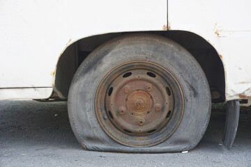 a rusted rim and a flat tire