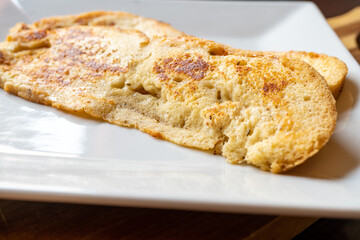 Two Thin Slices of Asiago Cheese Bread French Toast