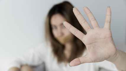 Stop hurting woman! young female person raised her hand for stop violence, sexual abuse, human trafficking, domestic violence and rape, International Day for the Elimination of Violence against Women