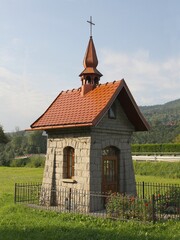 Fototapeta na wymiar rural landscape small,stony chapel in village 