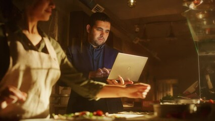 In Restaurant Small Business Owners: Male and Female Business Partners Use Laptop Computer. Authentic Pizza Place Cooking Delicious Organic Eco Food. Two Entrepreneurs Working on Online Order in Shop