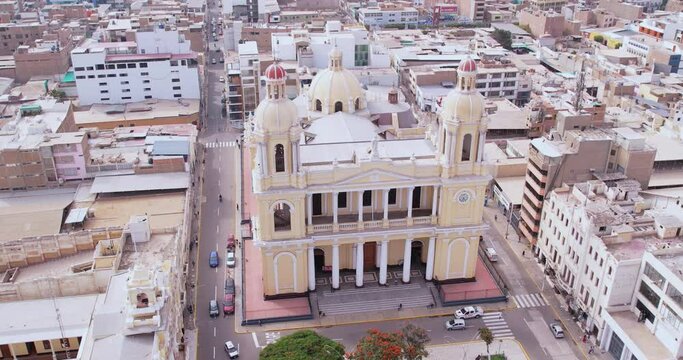 Amazing zoom out drone shot of the famous city center of Chiclayo, Peru and its cathedral in the city's main park.