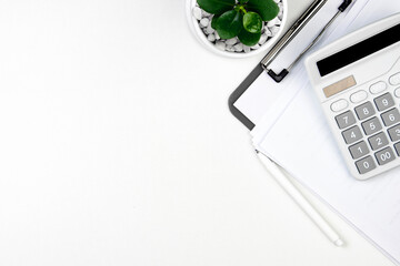 top view of modern white office desk with computer keyboard, blank notebook page and other...