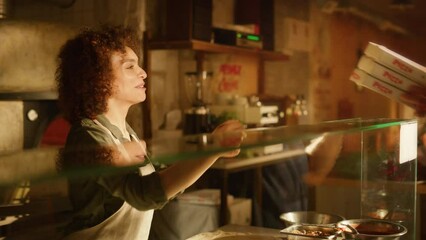 In Small Business Family Restaurant: Professional Couple of Chefs Preparing Pizza, Traditional Family Recipe, Giving Boxes to a Happy Customer. Online Order Delivery Pizzeria, Cooking Organic Food - Powered by Adobe