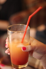 hand holding a cocktail