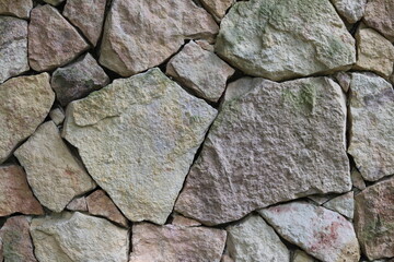 Natural old grey stone wall texture background.