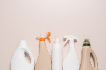 Bottles without labels with detergent on light background. Cleaning service concept. Advertising for cleaning products
