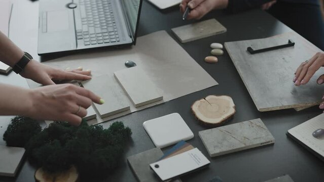 Interior design studio. Designers with architects and clients select solutions and combinations of materials for the interior of the room.