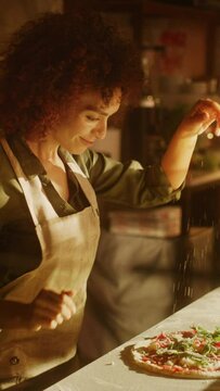 Vertical Screen Restaurant Professional Female Chef Preparing Pizza, Adding Ingredients, Special Sauce, Cheese, Traditional Family Recipe. Authentic Pizzeria with Delicious Organic Food. Slow Motion
