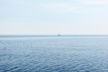 Boat on blue sea surface aerial view