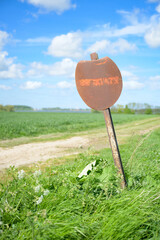 Faded road sign in the countryside