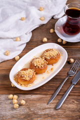 Milky kemalpasa dessert. Dessert with milk and hazelnuts on wooden background. Traditional Turkish cuisine. Close-up. local name sutlu kemalpasa tatlisi