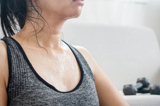 sweaty woman resting from exercise, tired from doing sport