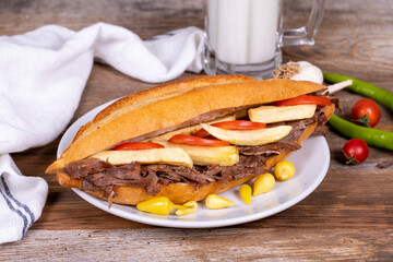 Doner kebab between bread. Meat doner kebab on wooden background. Traditional Turkish cuisine. close up