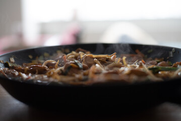 frying pan with meat and vegetables