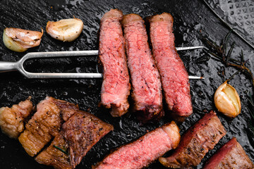 steak dinner with a significant slice cutting seasoning with rosemary garlic