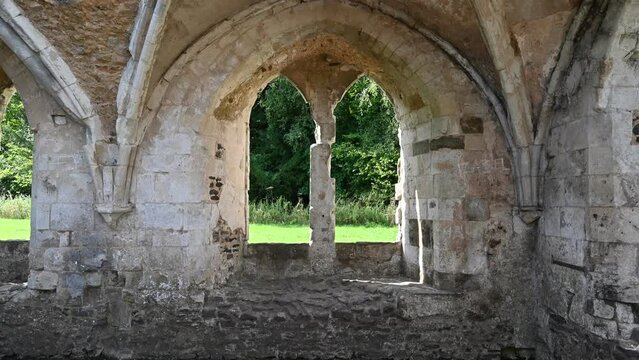 The roofless interior of Norman Abbey ruins in the UK. 