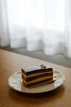 opera cake on white dish. Homemade bakery concept.