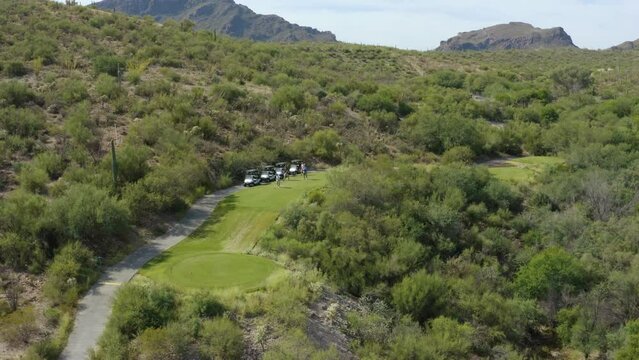 Golfer driving golf ball onto fairway. Desert Cactus Majave Sonoran southern luxury golf course. Shot on 4k DJI Mavic 2 Pro. Starr Pass Golf Club Tucson, Arizona United States