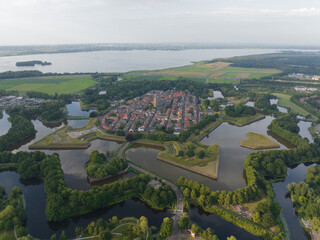 Fortified ancient old historic town of Naarden Vesting overhead aerial drone view of monumental ancient fort at the Zuiderwaterlinie medieval fortress defenisive vest landmark in The Netherlands.