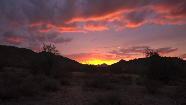 Sunburst Arizona desert sunset. Colorful cloudy flair Sonoran desert mountain range real life. Shot on 4k SONY A7RIII. Phoenix, Arizona United States