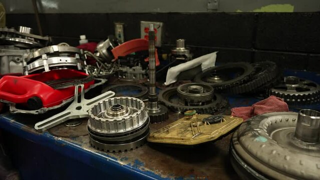 Transmission clutch repair on a mechanic shop workbench. Car repair garage service center. Shot on 4k SONY A7SIII
