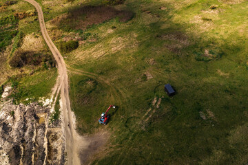 Excavator machinery on archaeological site, aerial shot from drone pov