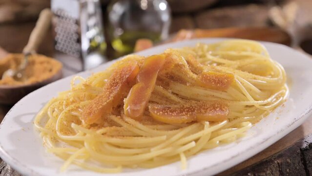 Spaghetti with bottarga. Typical Sardinian Cuisine. A dish with traditional Italian pasta from the South, dried sardine roe, lemon and pasta. High quality 4k footage