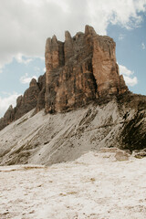 Fototapeta premium Tre cime di lavaredo in the Alps in Europe. Rock stone landscape in the mountains. Nobody on the image. rocky scenery, blue sky, clouds in the sky. 