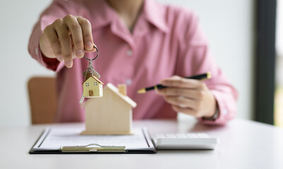 Real estate agents are offering house keys with a contract of sale.