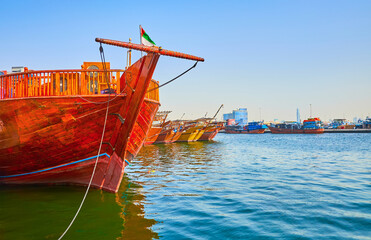 The moored dhow boats on Dubai Creek, UAE - obrazy, fototapety, plakaty