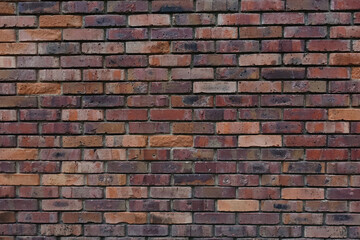 Texture of an old brick wall. taken frontally. The stones have red and brown tones