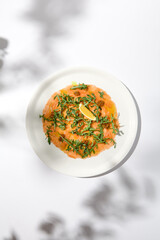 Salmon carpaccio with arugula on white background in summer day. Fish appetizer - salmon carpaccio...