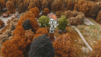 Aerial view of a brick clock tower in the fall town