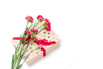 Red mini carnation and gift box. Concept of giving present at mother's day as surprise, flat lay, top view On White Background