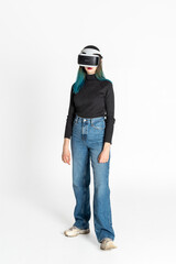 Virtual reality. A teenage girl with blue hair wearing virtual reality glasses watches movies or plays video games, isolated on a white background. A cheerful girl looking at VR glasses