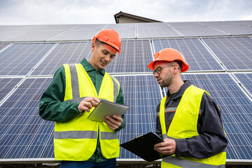 young hardy men in overalls arrived to discuss a plan to install solar panels.