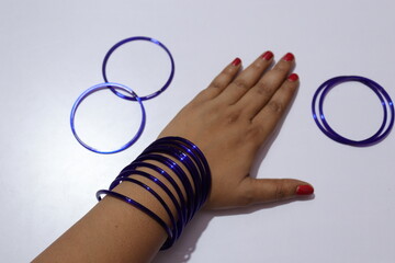 Woman's  Blue Colour many bangles on her wrist Isolated white background