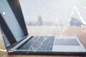 Multi exposure of abstract creative financial chart with world map on laptop background, research and analytics concept