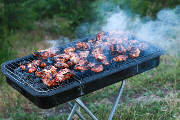 Meat on the grill. Cooking chicken on the barbecue