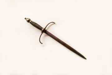 Antique steel dagger for the left hand with a beautiful handle isolated on a white background,...