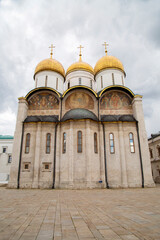 Assumption Cathedral in the Kremlin against the background of white clouds on a clear sunny day, Moscow. Sights of Russia. Architecture of World Tourism.