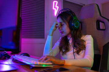 Eyes tired. Gamer and E-Sport online of Asian woman playing online computer video game with...